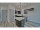 Modern kitchen with stainless steel appliances, a kitchen island, and sleek gray cabinetry at 382 E Erin St # 2, Pahrump, NV 89048