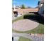 Spacious backyard featuring artificial turf, a circular brick patio, and a built-in grill at 3862 E Summit Ave, Pahrump, NV 89061