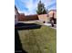 Low-maintenance backyard featuring artificial turf, a brick-lined patio area, and a built-in grill at 3862 E Summit Ave, Pahrump, NV 89061