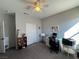 Bright bedroom featuring a ceiling fan, neutral walls, and functional desk space with ample natural light at 3862 E Summit Ave, Pahrump, NV 89061