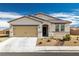 Charming single-story home featuring a beige facade, landscaped front yard, and a two-car garage at 3862 E Summit Ave, Pahrump, NV 89061