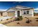 View of front exterior, showcasing desert landscaping, beige facade, and a covered entryway at 3862 E Summit Ave, Pahrump, NV 89061