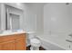 Clean bathroom featuring a tub, toilet, and sink with natural wood cabinet at 4020 Smokey Fog Ave # 201, North Las Vegas, NV 89081