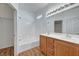 Bright bathroom featuring double sinks, bathtub, shower, and modern lighting fixtures at 4020 Smokey Fog Ave # 201, North Las Vegas, NV 89081