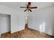 Bedroom featuring wood floors, ceiling fan, closet, and white walls at 4020 Smokey Fog Ave # 201, North Las Vegas, NV 89081