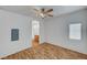 Clean bedroom featuring wood flooring, ceiling fan, and ensuite bathroom access at 4020 Smokey Fog Ave # 201, North Las Vegas, NV 89081