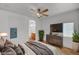 Comfortable bedroom with ceiling fan, mounted television, and ensuite bathroom access at 4020 Smokey Fog Ave # 201, North Las Vegas, NV 89081