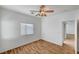 Bright bedroom with wood flooring, ceiling fan, and natural light from the window at 4020 Smokey Fog Ave # 201, North Las Vegas, NV 89081