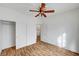 Bedroom featuring wood floors, ceiling fan, closet, and white walls at 4020 Smokey Fog Ave # 201, North Las Vegas, NV 89081