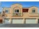 Inviting exterior featuring a multi-unit home with individual garages and peach stucco at 4020 Smokey Fog Ave # 201, North Las Vegas, NV 89081