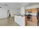 Open kitchen features granite countertops, stainless steel appliances, and access to living area at 4020 Smokey Fog Ave # 201, North Las Vegas, NV 89081