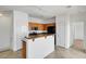 Bright kitchen with granite countertops, wooden cabinets, and a breakfast bar at 4020 Smokey Fog Ave # 201, North Las Vegas, NV 89081