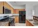 Bright kitchen with wooden cabinetry and stainless steel oven and microwave at 4020 Smokey Fog Ave # 201, North Las Vegas, NV 89081