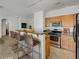 Well-lit kitchen features stainless steel appliances, breakfast bar, and ample countertop space at 4020 Smokey Fog Ave # 201, North Las Vegas, NV 89081