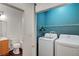 Convenient laundry room and bathroom setup with washer, dryer, and functional sink at 4020 Smokey Fog Ave # 201, North Las Vegas, NV 89081