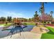 A colorful playground is set amidst lush landscaping, perfect for Gathering fun at 4020 Smokey Fog Ave # 201, North Las Vegas, NV 89081