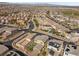 An aerial shot features closely built homes with modern solar panels, and shared community spaces in a planned neighborhood at 408 Gracious Way, Henderson, NV 89011