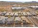 An aerial view showcases the neighborhood's well-maintained homes and new commercial development in the distance at 408 Gracious Way, Henderson, NV 89011