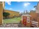 Landscaped backyard with artificial turf, playhouse, and swing set at 408 Gracious Way, Henderson, NV 89011