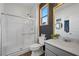 Modern bathroom features tiled shower with glass door, vanity, and decorative accent wall at 408 Gracious Way, Henderson, NV 89011