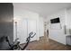 Bright bedroom with closet, white walls, wood floors, and a stationary bike at 408 Gracious Way, Henderson, NV 89011