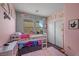 Charming pink bedroom featuring a bunk bed, plush rug, and ample natural light from the windows at 408 Gracious Way, Henderson, NV 89011