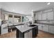 Beautiful kitchen with gray cabinets, an island with granite counters, and an eat-in kitchen table at 408 Gracious Way, Henderson, NV 89011