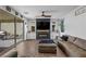 Elegant living room with modern fireplace, ceiling fan, and access to the outdoor patio at 408 Gracious Way, Henderson, NV 89011