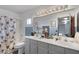 Well-appointed bathroom showcasing a dual-sink vanity and a tub with a shower at 4446 Scarlet Sea Ave, North Las Vegas, NV 89031