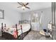 Bright bedroom featuring wood floors, a ceiling fan, and a floral-themed bed at 4446 Scarlet Sea Ave, North Las Vegas, NV 89031