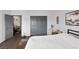 Cozy bedroom featuring wood floors, a storage chest, a large closet, and neutral-colored walls at 4446 Scarlet Sea Ave, North Las Vegas, NV 89031