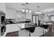 Modern kitchen featuring white cabinets, black countertops, stainless steel appliances, and an island with bar seating at 4446 Scarlet Sea Ave, North Las Vegas, NV 89031