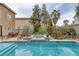 Backyard pool and spa with mature trees and patio furniture provide a backyard oasis at 4446 Scarlet Sea Ave, North Las Vegas, NV 89031