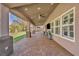 Long, covered patio featuring recessed lighting, ceiling fans, and a view of the backyard and outdoor kitchen at 4516 Whelk Pl, North Las Vegas, NV 89031