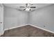 This bedroom features dark wood floors and a ceiling fan at 4516 Whelk Pl, North Las Vegas, NV 89031