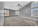 Bedroom with plush carpet, ceiling fan, and bright windows at 4516 Whelk Pl, North Las Vegas, NV 89031