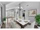 Dining area showcasing a modern marble table and hardwood floors with large windows at 4516 Whelk Pl, North Las Vegas, NV 89031