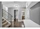 Hallway featuring hardwood floors leading to the laundry room, staircase with iron railing at 4516 Whelk Pl, North Las Vegas, NV 89031