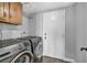 Functional laundry area with overhead cabinet and washer and dryer at 4516 Whelk Pl, North Las Vegas, NV 89031