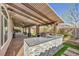 Spacious back patio featuring an outdoor kitchen with stone accents and a built-in grill overlooking the backyard at 4516 Whelk Pl, North Las Vegas, NV 89031