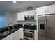 Close-up of a kitchen area with white cabinets, stainless steel appliances, and black countertops at 4525 Dean Martin Dr # 503, Las Vegas, NV 89103