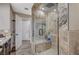 Bathroom with an elegant glass shower, stone tiling and shower seat at 4625 W Robindale Rd, Las Vegas, NV 89139