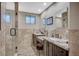 Bathroom showcasing dual vanities, framed mirrors, and a glass-enclosed shower at 4625 W Robindale Rd, Las Vegas, NV 89139