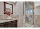 Bathroom featuring a granite-topped vanity and glass enclosed tile shower at 4625 W Robindale Rd, Las Vegas, NV 89139