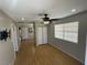 Bright bedroom with hardwood flooring, ceiling fan, closet, and a large window offering natural light at 4625 W Robindale Rd, Las Vegas, NV 89139