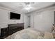 Bedroom with a ceiling fan, wainscoting and closet storage at 4625 W Robindale Rd, Las Vegas, NV 89139