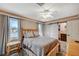 Bedroom showcasing a log-style bed frame, two windows and access to an ensuite bathroom at 4625 W Robindale Rd, Las Vegas, NV 89139