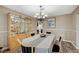 Dining room with hardwood-style floors and backyard views, adjacent to the modern kitchen at 4625 W Robindale Rd, Las Vegas, NV 89139