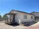 Exterior view of a detached casita with a wooden porch, secure entry, and adjacent garage at 4625 W Robindale Rd, Las Vegas, NV 89139