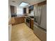This kitchen features stainless steel appliances and wood cabinets at 4625 W Robindale Rd, Las Vegas, NV 89139